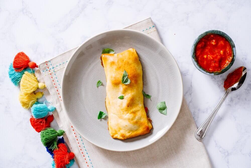 Customize Healthy and Homemade Hot Pockets with fresh ingredients for a portable, freezer-friendly lunch or after-school snack.
