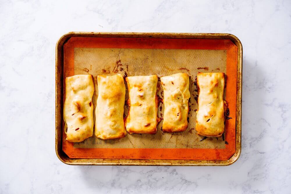 Customize Healthy and Homemade Hot Pockets with fresh ingredients for a portable, freezer-friendly lunch or after-school snack.