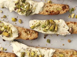 Pistachio, White Chocolate and Cardamom Biscotti from Holley Grainger - a holiday potluck food that travels well